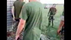 Russian Army Guys Bang A Hoe Outdoors.